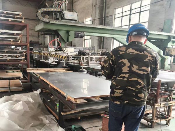 1 Worker at manufacture workshop operating cidan folding machine; Shutterstock ID 232675477; purchase_order: -; job: -; client: -; other: -