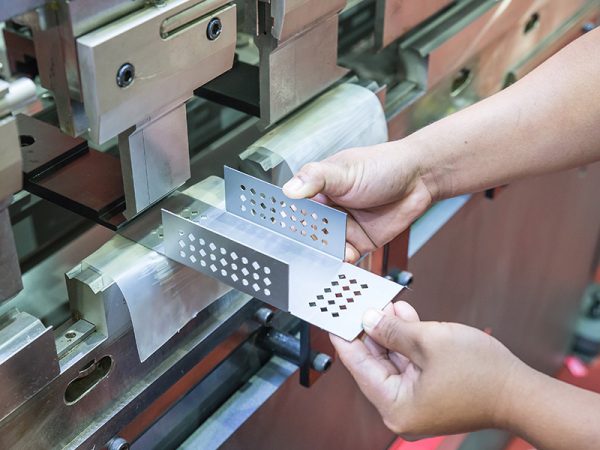 Sheet Metal Bending1 Worker at manufacture workshop operating cidan folding machine; Shutterstock ID 232675477; purchase_order: -; job: -; client: -; other: -